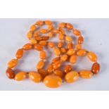 AN AMBER BEAD NECKLACE. 90cm long, largest bead 19.2mm, weight 54g