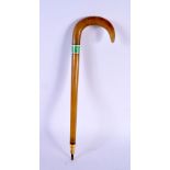A RARE 19TH CENTURY MIDDLE EASTERN CARVED RHINOCEROS FULL LENGTH CHILDS WALKING CANE with enamel ban
