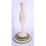 A 19TH CENTURY ENGLISH EGYPTIAN REVIVAL PORCELAIN CANDLESTICK formed as a figure. 22 cm high.