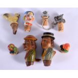 A COLLECTION OF NOVELTY BOTTLE STOPPERS including a pair of Bavarian examples. Largest 11 cm long. (