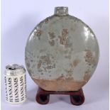 AN UNUSUAL EARLY 20TH CENTURY CHINESE KOREAN MOON FLASK with natural glaze pitting. 30 cm x 20 cm.