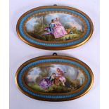 A PAIR OF 19TH CENTURY FRENCH SEVRES PORCELAIN PLAQUES painted with figures in landscapes. 25 cm x 1