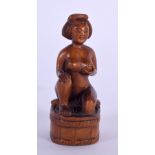 A JAPANESE TAISHO PERIOD CARVED BOXWOOD NETSUKE formed as a nude female. 6 cm x 3 cm.