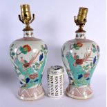 A PAIR OF 19TH CENTURY FRENCH SAMSONS OF PARIS PORCELAIN LAMPS painted in the Kangxi style. 34 cm hi