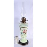 A LARGE LATE VICTORIAN OPALINE GLASS OIL LAMP. 59 cm high.