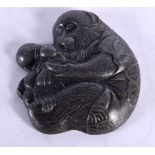 A 19TH CENTURY JAPANESE MEIJI PERIOD MIXED METAL PLAQUE modelled as a monkey pouring a gourd. 6.5 cm