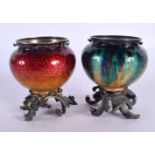 A PAIR OF EARLY 20TH CENTURY FRENCH SILVER AND ENAMEL VASES upon foliate vases. 7 cm x 6 cm.