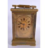 A 19TH CENTURY FRENCH REPEATING BRASS CARRIAGE CLOCK with architectural type dial. 18 cm high inc ha
