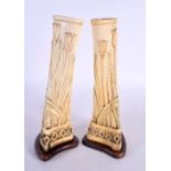 A PAIR 19TH CENTURY FRENCH CARVED BONE PRISONER OF WAR VASES decorated with foliage. 23 cm high.