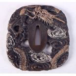 A JAPANESE TSUBA DECORATED WITH A DRAGON. 8.3cm x 7.4cm, weight 147g