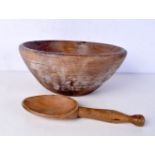An early wooden butter bowl together with a wooden spoon 29 cm.