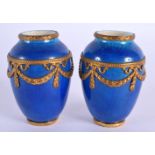 AN UNUSUAL PAIR OF FRENCH SEVRES PORCELAIN BLUE VASES with gilt metal mounts. 8 cm high.