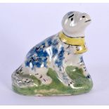 AN 18TH CENTURY EUROPEAN DELFT FAIENCE PORCELAIN FIGURE OF A HOUND modelled recumbent. 5.5 cm x 6 cm