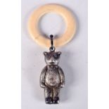 AN ANTIQUE BONE TEETHING RING WITH A RATTLE IN THE FORM OF A BEAR. 11.4cm x 5.3cm, weight 15g