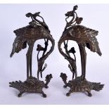 A PAIR OF 19TH CENTURY JAPANESE MEIJI PERIOD BRONZE OKIMONO modelled as cranes upon minogame. 24 cm