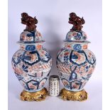 A PAIR OF 18TH/19TH CENTURY JAPANESE EDO PERIOD IMARI VASES AND COVERS painted with landscapes and h