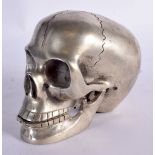 A CONTEMPORARY SILVER PLATED SKULL. 12 cm x 9 cm.