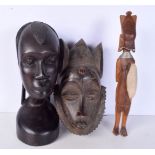 A large carved ebony African tribal head together with a Congolese wooden tribal mask and another f