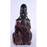 A 16TH/17TH CENTURY CHINESE LACQUERED BRONZE FIGURE OF A GUARDIAN Ming, modelled holding a ritual it