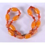 AN ART DECO AMBER TYPE AGATE NECKLACE. 50 cm long, largest bead 2.75 cm wide.