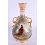 A ROYAL WORCESTER TWIN HANDLED PORCELAIN VASE by James Stinton. 14 cm high.