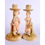 A PAIR OF ROYAL WORCESTER FIGURAL CANDLESTICKS. 19 cm high.