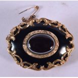 AN EARLY VICTORIAN YELLOW METAL AND ENAMEL MOURNING BROOCH. 16.8 grams. 4 cm x 3 cm.