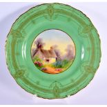 Royal Worcester plate painted with a cottage scene under a green art deco border signed by Raymond R