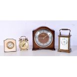 A small brass carriage clock together with a mantle clock ,an alarm clock and another clock (4)