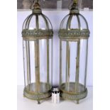 A pair of large metal and glass lanterns with openwork Islamic style decoration 89 cm (2)