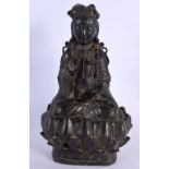 A 16TH/17TH CENTURY CHINESE BRONZE FIGURE OF A BUDDHA Ming, modelled upon a lotus capped base. 27 cm