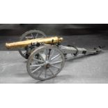 A LARGE ANTIQUE BRONZE CANNON upon a painted wooden base. 80 cm x 25 cm.