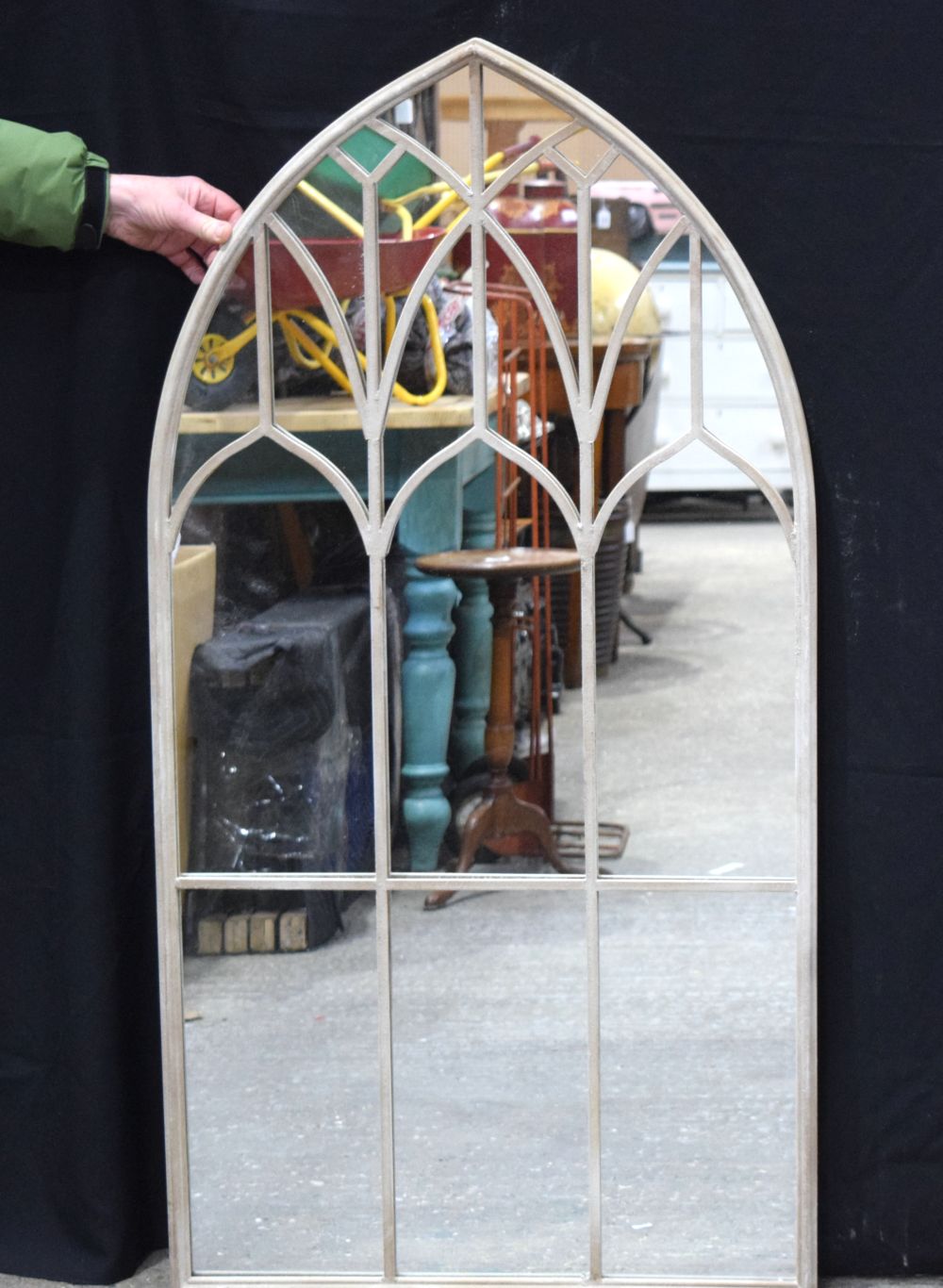 A metal arch window style mirror 126 x 65 cm.
