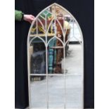 A metal arch window style mirror 126 x 65 cm.