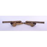 A PAIR OF ANTIQUE GENTLEMANS BRONZE AND CARVED WOOD DESK CANNONS. 24 cm long.