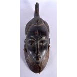 AN EARLY 20TH CENTURY AFRICAN TRIBAL CARVED WOOD BAULE/GURO MASK Ivory Coast. 45 cm x 20 cm.