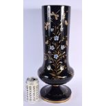 A LARGE VICTORIAN BLACK OPALINE GLASS VASE decorated with foliage and birds. 46 cm x 12 cm.
