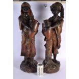 A LARGE PAIR OF 19TH CENTURY AUSTRIAN COLD PAINTED TERRACOTTA FIGURES modelled holding an amphora. 6