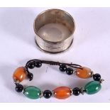 A SILVER NAPKIN RING and a jade bracelet. Silver 17 grams. (2)