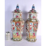 A VERY LARGE PAIR OF 19TH CENTURY CHINESE CANTON FAMILLE ROSE VASES AND COVERS painted with figures