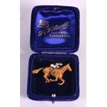 A FINE 9CT GOLD AND ENAMEL EQUESTRIAN JOCKEY HORSE BROOCH. 14.6 grams. 4.5 cm x 3 cm.