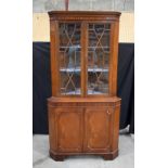 A mid-Century glass fronted mahogany corner cabinet. 179 x 92 x 52cm.