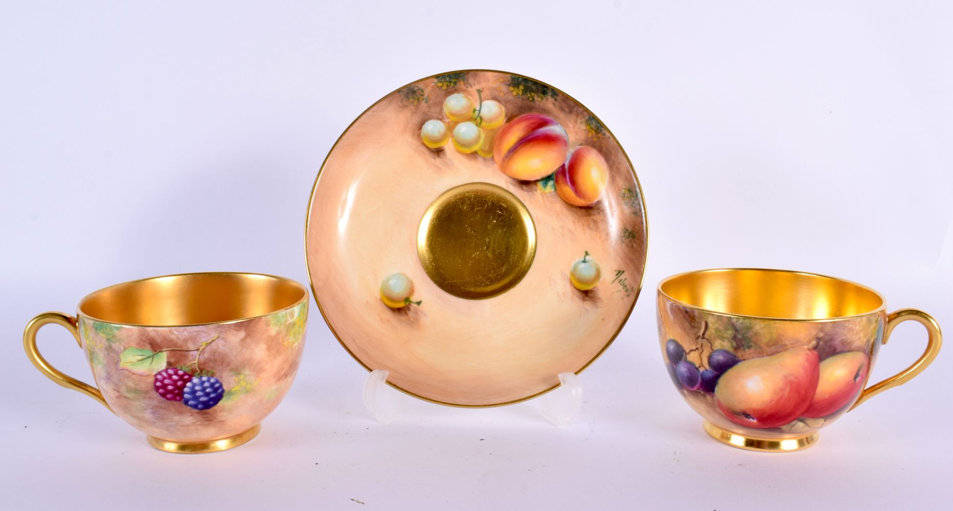 TWO ROYAL WORCESTER FRUIT PAINTED CUPS by Cox & Smith, together with a saucer by another Worcester a