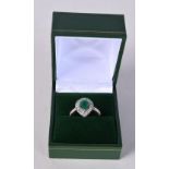 AN 18CT GOLD WHITE GOLD AND EMERALD RING. N. 3 grams.