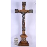 A LARGE 19TH CENTURY EUROPEAN CORPUS CHRISTI CRUCIFIX probably silver, modelled upon an oak plinth.