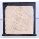 A carved stone tile depicting a Lion 12.5 x 12.5cm.