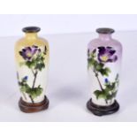 A pair of small enamelled metal vases decorated with flowers 12 cm (2)