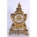 A LARGE 19TH CENTURY FRENCH GILT BRONZE MANTEL CLOCK of scrolling rococo form. 36 cm x 18 cm.