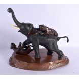 A 19TH CENTURY JAPANESE MEIJI PERIOD BRONZE AND IVORY ELEPHANT modelled being attacked by tiger. 30