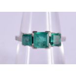 AN 18CT WHITE GOLD RING SET WITH 3 EMERALDS. Size N, weight 3.5g